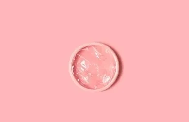 menstrual disc on pink background.