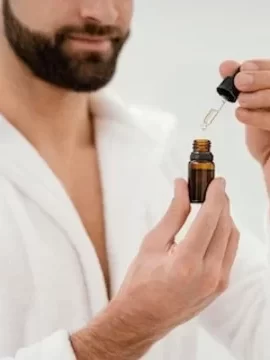 Man using muuchstac herbal skin lightening oil