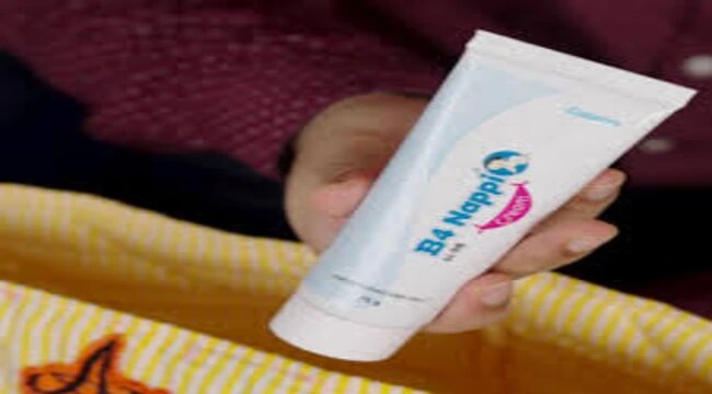 In the image showing a woman hand holding b4 nappy cream