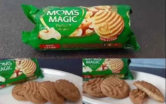In the image showing a green packet of mom's magic biscuit and biscuits on white plate.