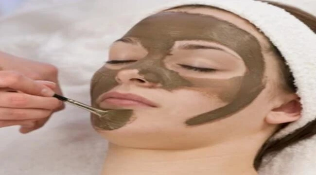 A girl applying coffee face pack