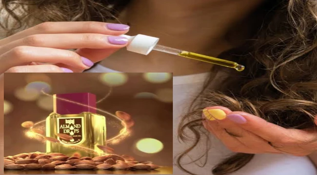 A woman applying Bajaj almond drop hair oil on her hair
