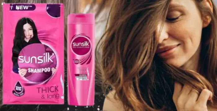 A woman showing the result for using sunsilk pink shampoo